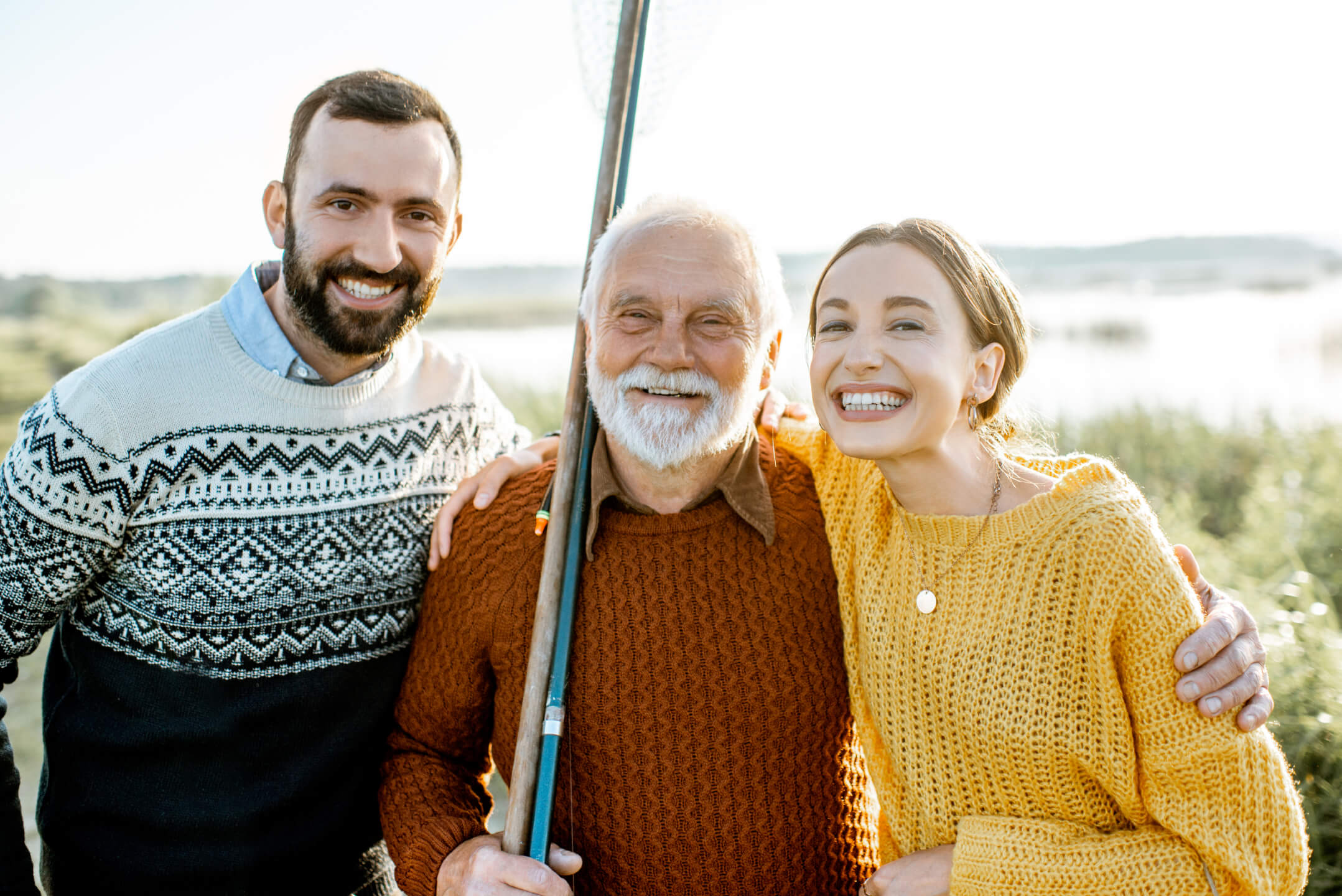Grandfather with son and daughter outdoors