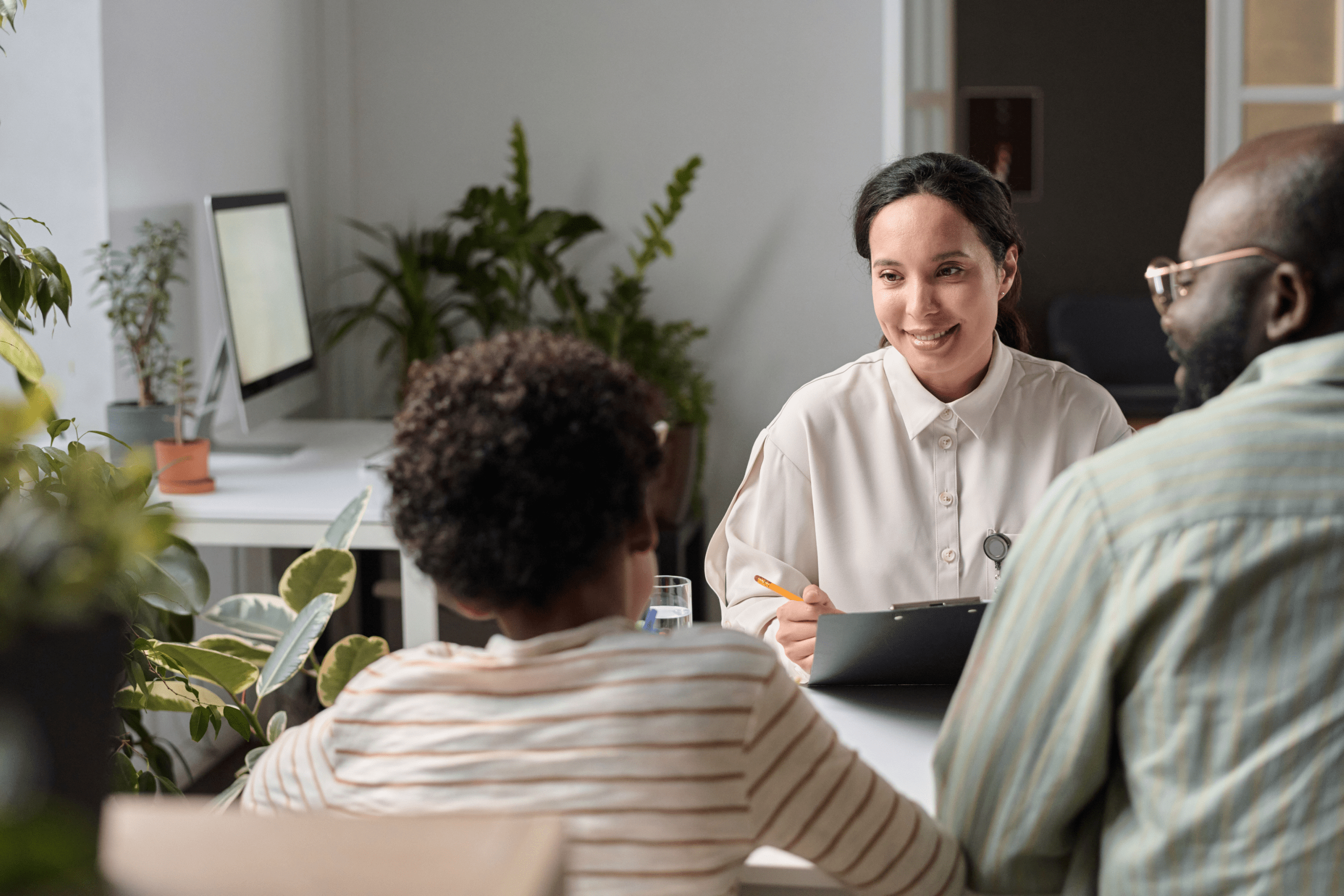 Smiling consultant talking to family in office